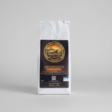 Dock Days Ground Coffee bag on a wooden surface with a neutral background